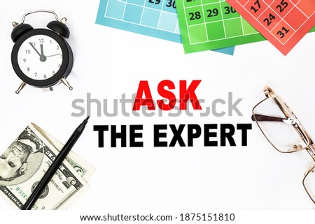 ASK THE EXPERT . text on the piece of paper on the green wood background