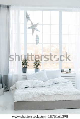 Bed with panoramic windows in the afternoon in December 2020