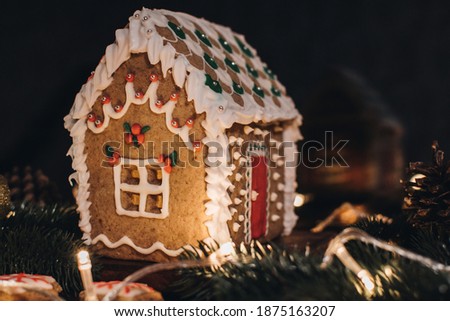Scandinavian hygge styled Christmas composition. Cozy winter homely scene with gingerbread house for Holidays. Christmas cookies.