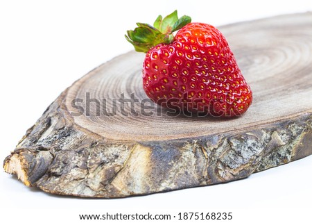 Red ripe strawberry lies on a wooden background. High quality photo