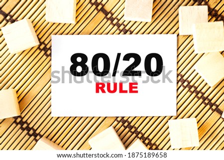 80'20 RULE word on wooden cubes. Concept wooden box on a beautiful wooden background