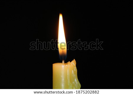 closeup shot of a burning candle with black background