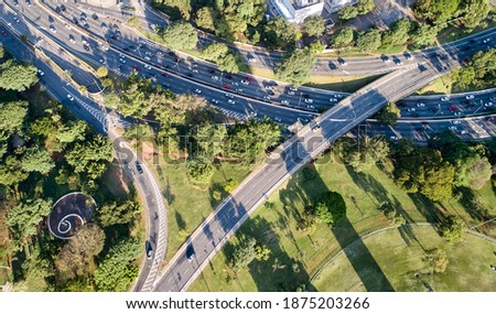 Aerial view of traffic in 23 de Maio avenue in Sao Paulo city  near to Ibirapuera Park, a very wooded region with a lot of nature preservation.