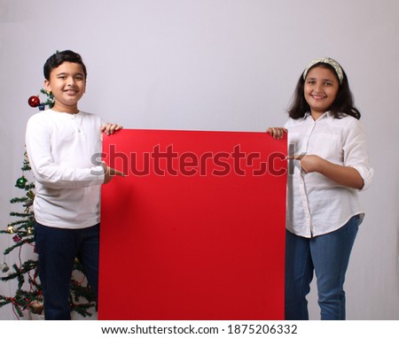 Indian kids Holding empty colourful cards or poster on christmas festival
