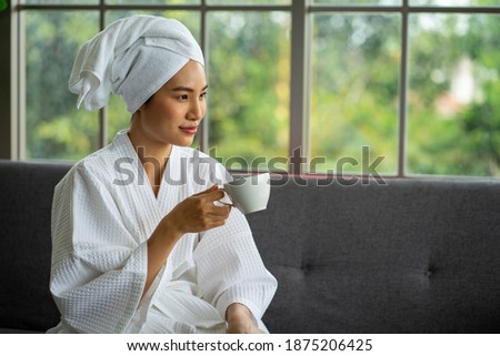 selected focus Asian young attractive woman wearing white bath robe sitting for Spa massage service.  Royalty-Free Stock Photo #1875206425