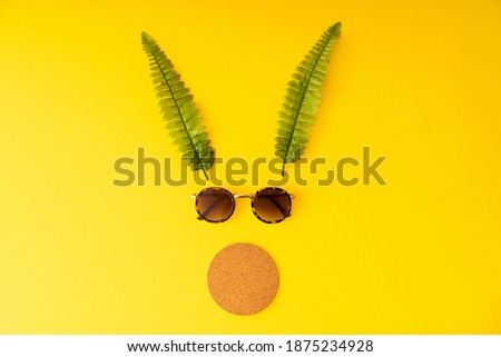 Reindeer silhouette with sunglasses on the yellow background. Top view isolated.