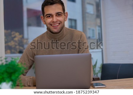 man at home working with laptop