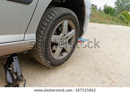 Photo of a car wheel replacement on the road