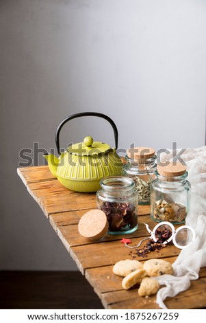 tea serve to the teapot on the wooden background and cookies
