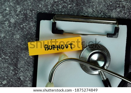 Burnout write on sticky notes on the table. Medical or Healthcare concept. Selective focus on Burnout Text
