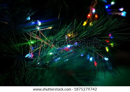 New year colourful lights on new year tree. Christmas garland in the dark. Illumination and party decoration concept. Background and wallpaper picture. Copy space. Close up photo, blurred background