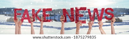 People Hands Holding Word Fake News, Snowy Winter Background