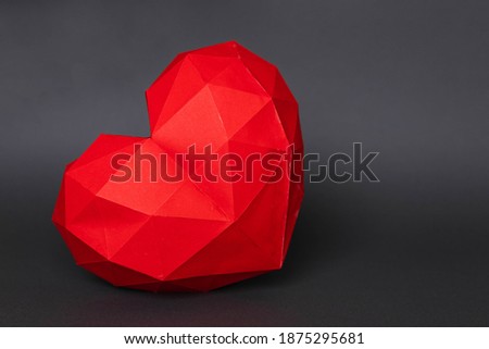 
Paper hearth with a shadow. Red polygonal paper heart for Valentine's Day or any other love invitations. Polygonal shape heart on a gray background.