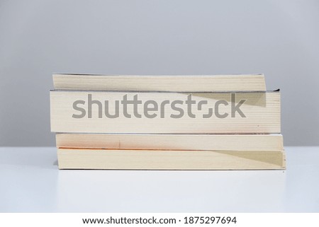Books stacked on top of each other. Close-up photo of the book. 
A stack of books lying on a white background, learning, education, study.
