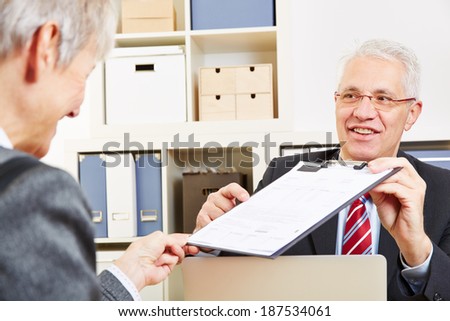 Consultant showing minutes of consultation to customer for a signature