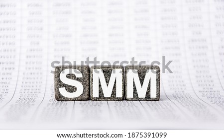 three stone cubes on the background of white financial statements, tables with the word SMM System Management Mode. Strong business concept