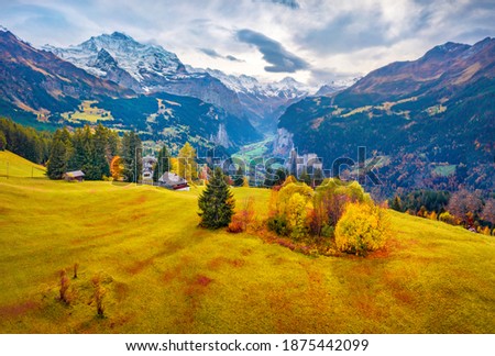 View from fAerial landscape photography. Colorful summer view from flying drone of Wengen village, district of Lauterbrunnen. Gloomy morning scene of Swiss Alps, Switzerland, Europe.