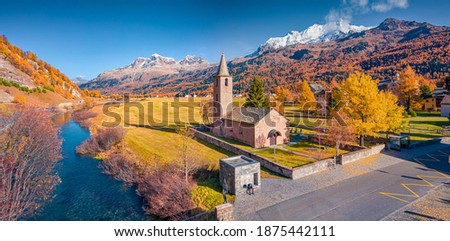 Aerial landscape photography. Colorful view from flying drone of San Lurench church in Sils im Engadin village. Bright morning scene of Swiss Alps, Switzerland, Europe.