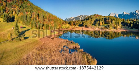 Aerial landscape photography. Exciting autumn view from flying drone of Wagenbruchsee lake. Stunning evening scene of Bavaria, Germany, Europe. Beautiful autumn scenery.
