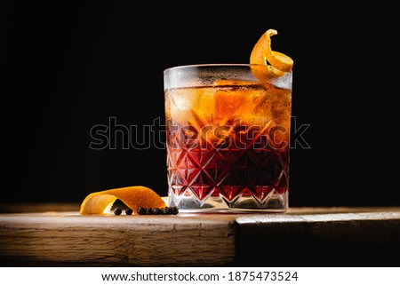 Cocktail Negroni on an old wooden board. Royalty-Free Stock Photo #1875473524