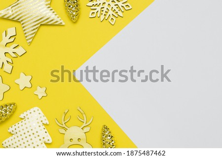 Christmas frame with baubles, decorations on Illuminating Yellow and Ultimate Gray background. Creative design demonstrating colors of the year 2021