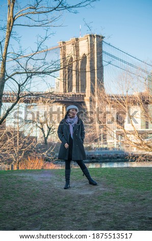 Sunshine day in New York City . Asian woman winter vacation at DUMBO NYC, Brooklyn Bridge, NYC.