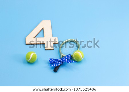 Tennis 4th Birthday Anniversary with tennis ball and racket with blue ribbon