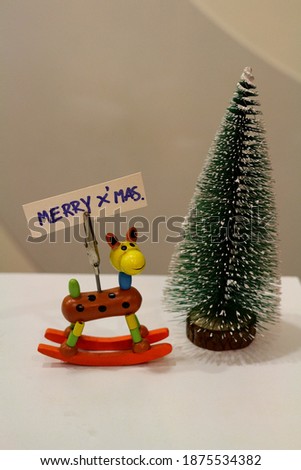 Cartoon puppets and small Christmas​ tree. It is picture associated with Christmas 