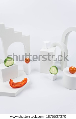 Aesthetic food photography on trendy white podium. Minimal food art still life concept.  Salad from cherry tomatoes, sweet pepper, cucumber on white background.