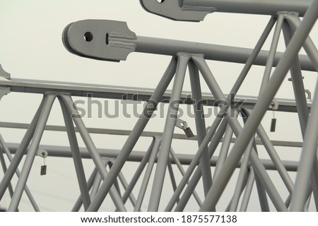 Boom spare part for construction crane, gray metal structures on gray background Stock photo with empty space for text and design. 