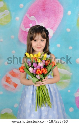 beautiful young girl holding bouquet of tulips at easter