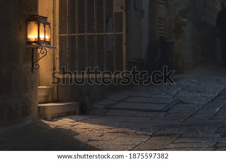 Menorah in a glass box - lit at the entrance to an ancient building in the Jewish Quarter in the Old City, Jerusalem, Israel Royalty-Free Stock Photo #1875597382