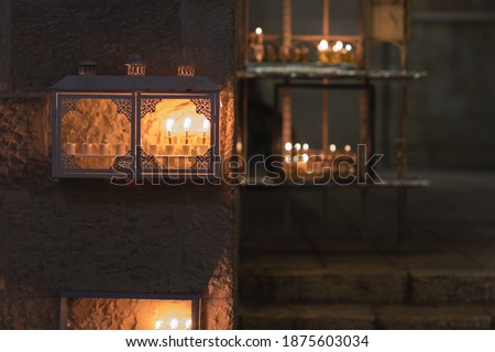 Many menorahs are lit at the entrance to an ancient house in the Jewish Quarter of the Old City, Jerusalem, Israel