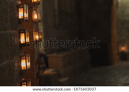 Many menorahs are lit at the entrance to an ancient building in the Jewish Quarter of the Old City, Jerusalem, Israel
