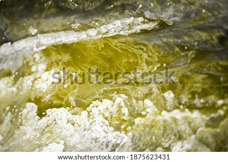 Abstraction. Photo of  fluid art. Yellow and grey. Natural luxury. The style includes swirls of marble or ripples of agate. Very beautiful yellow paint with the addition of gold powder
