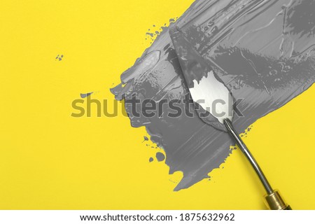 Colors of the year 2021 Ultimate Gray and Illuminating background.  Ultimat gray paint on yellow illuminatig background.