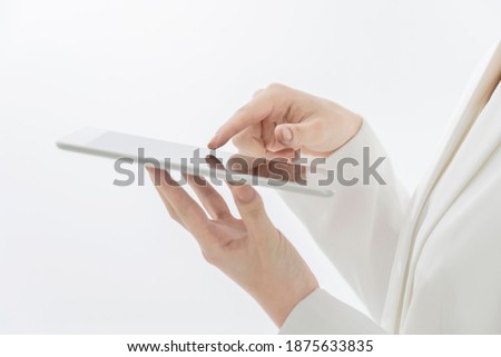 Business woman who touches the screen of a tablet