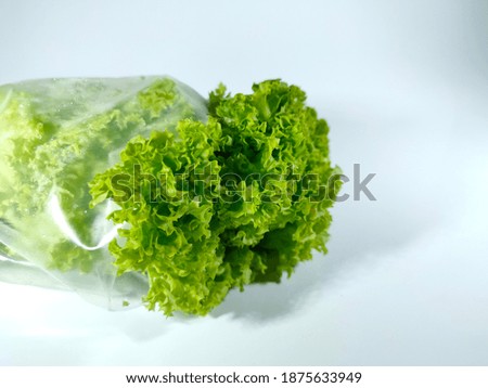 Selective focus.Green salad and measuring tape isolated on white background.Healthcare and diet concept.