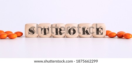 top view blocks with word STROKE on the white background with pills