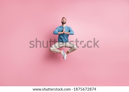 Full length photo of sweet peaceful young guy wear blue pullover jumping enjoying yoga isolated pink color background Royalty-Free Stock Photo #1875672874