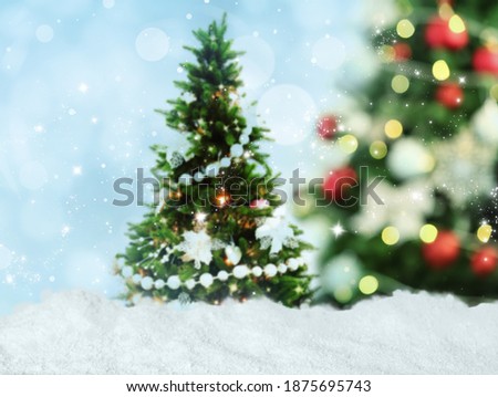 Snow and beautiful decorated Christmas tree. Bokeh effect