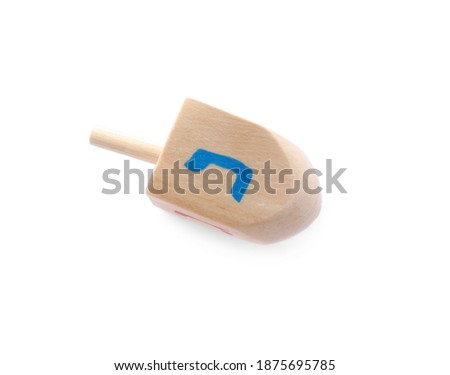 Wooden Hanukkah traditional dreidel with letter Nun isolated on white, above view