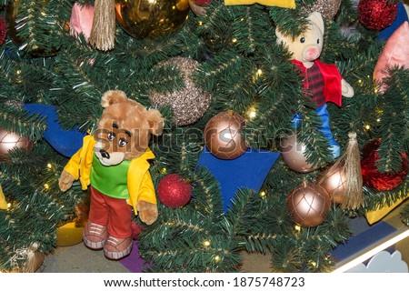 Christmas tree decor with balloons and children's soft toys. Close up .