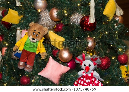 Christmas tree decor with children's soft toys. Close up .