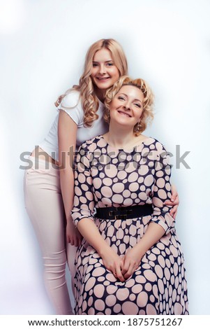 mother with teen daughter together posing happy smiling isolated on white background with copyspace, lifestyle people concept