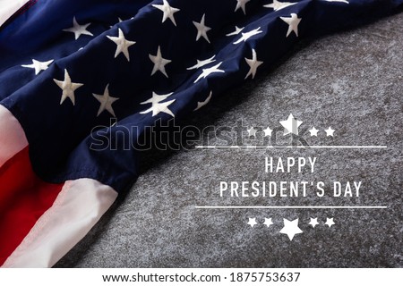 United States National Holidays. American or USA Flag with "HAPPY PRESIDENT'S DAY" text on cement background, President Day concept Royalty-Free Stock Photo #1875753637