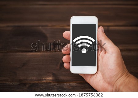 Home office background. Home Wifi network. Wireless internet connection. Internet symbol background. Wi-fi icon. Hands holding smartphone. Mobile device network signal.