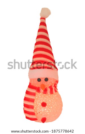Christmas decoration isolated. Close-up of a yellow illuminated happy cute winter snowman with red white striped hat and scarf isolated on a white background. Macro photograph.