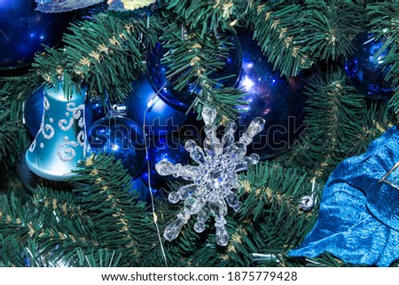Artificial fir tree with Christmas decorations in blue and blue color scheme. Close up. Christmas background