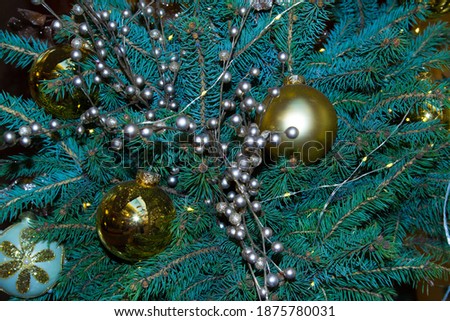 Artificial fir tree with Christmas decorations in silver beads and beads. Close up. Christmas background